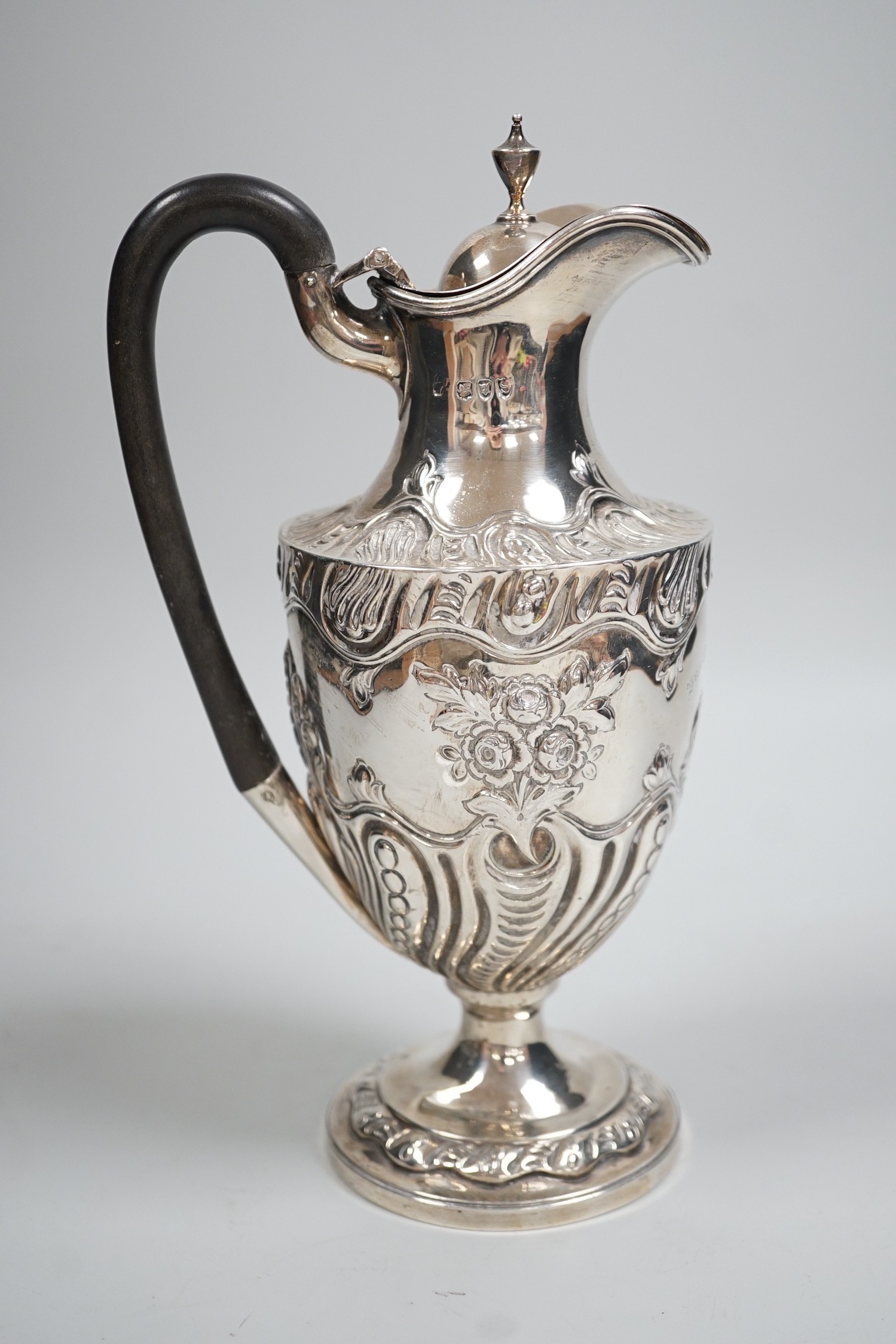 A late Victorian repousse silver pedestal hot water jug, Charles Stuart Harris, London, 1893, height 25cm, gross weight 13.3oz.